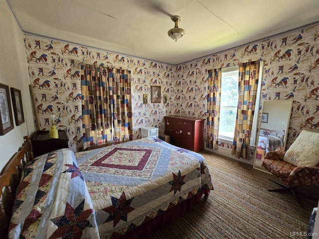 carpeted bedroom featuring wallpapered walls