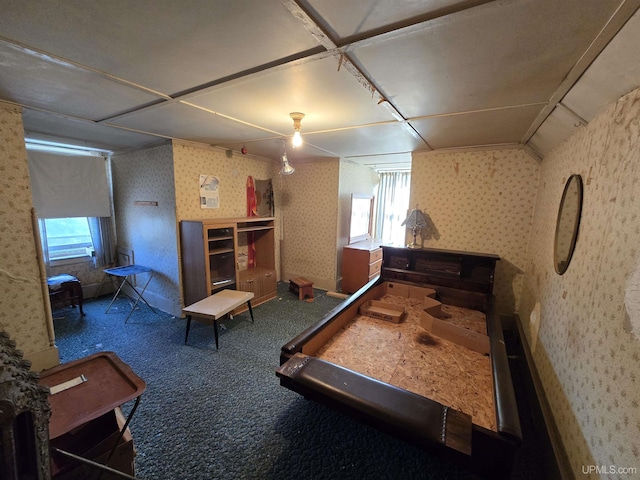 carpeted bedroom with wallpapered walls and multiple windows