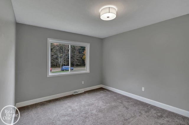 carpeted empty room with baseboards and visible vents