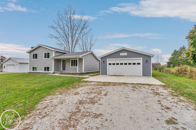 tri-level home featuring a garage, an outbuilding, and a front yard