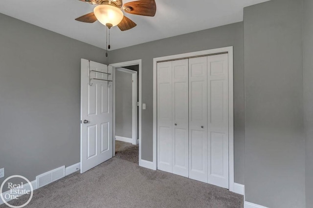 unfurnished bedroom with ceiling fan, carpet floors, baseboards, visible vents, and a closet