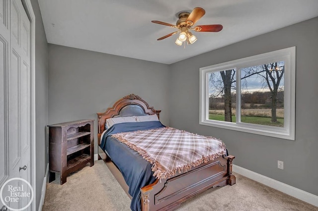 carpeted bedroom with baseboards and ceiling fan