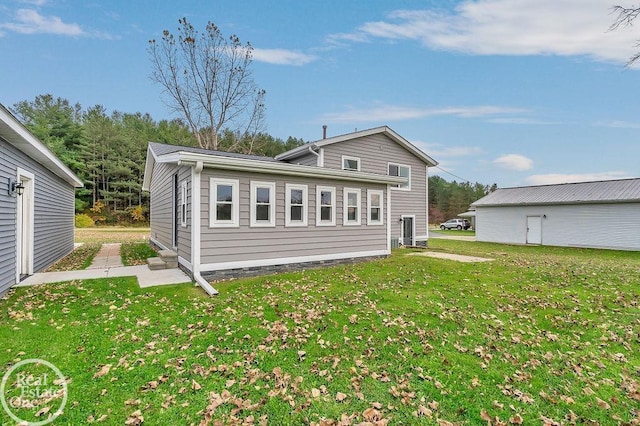 back of property featuring a yard and a patio area