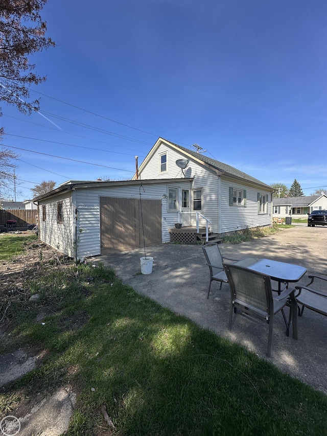 back of house featuring a garage and a patio