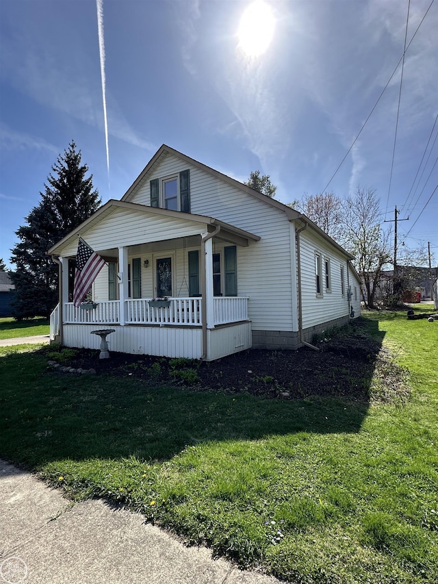 view of front of home with covered porch and a front yard