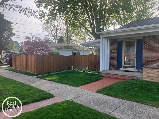 view of yard with fence and a porch