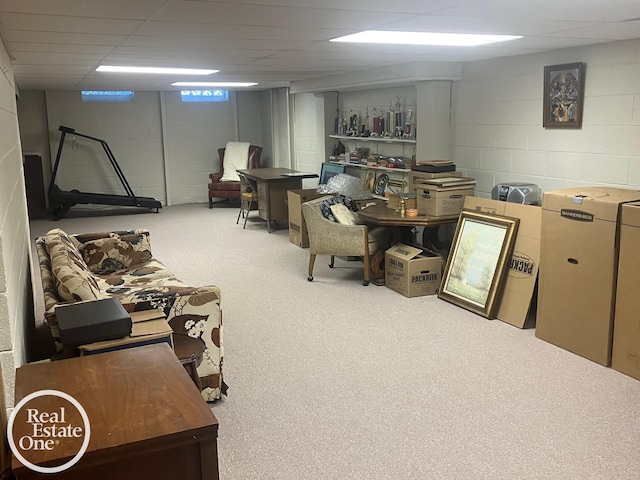basement featuring carpet flooring and concrete block wall