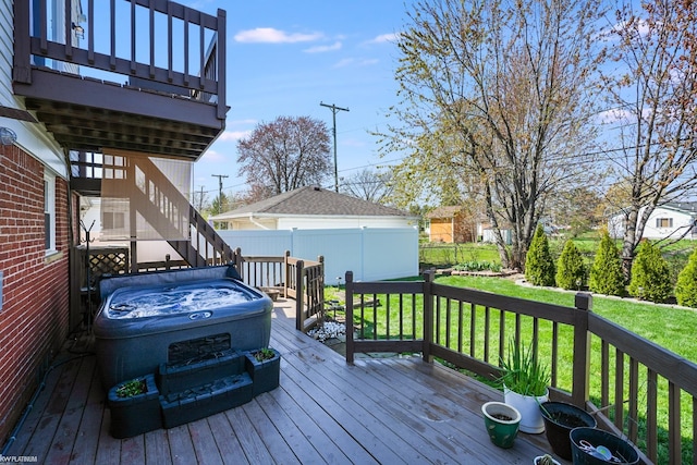 wooden terrace with a lawn, fence, and stairs