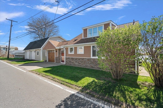 view of front of house with a garage, a front yard, stone siding, and concrete driveway