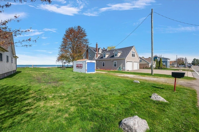 view of yard featuring a garage and driveway