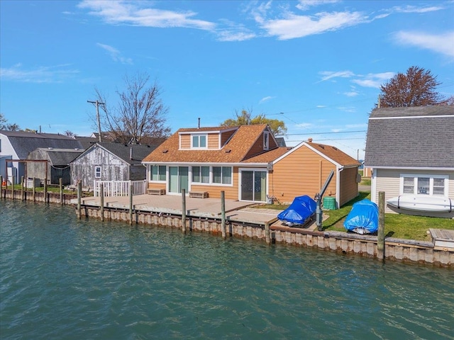 back of house featuring a water view and a patio