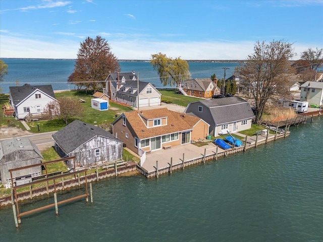 drone / aerial view with a residential view and a water view