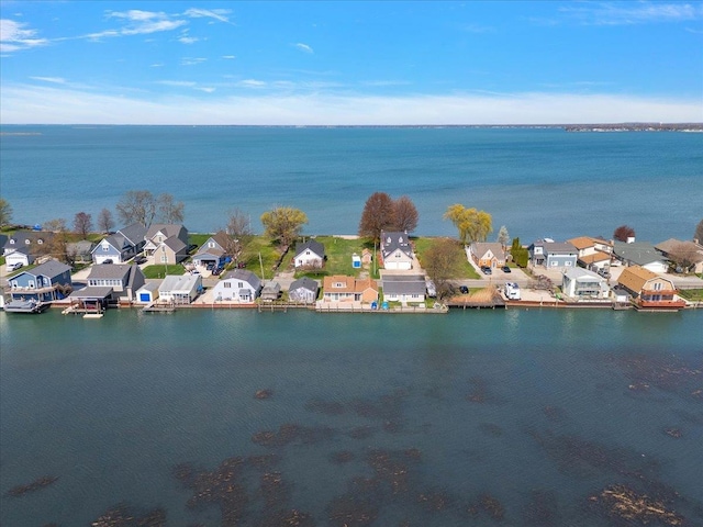 birds eye view of property with a water view and a residential view