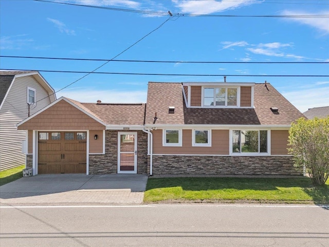 view of front of property featuring an attached garage, a shingled roof, stone siding, and concrete driveway