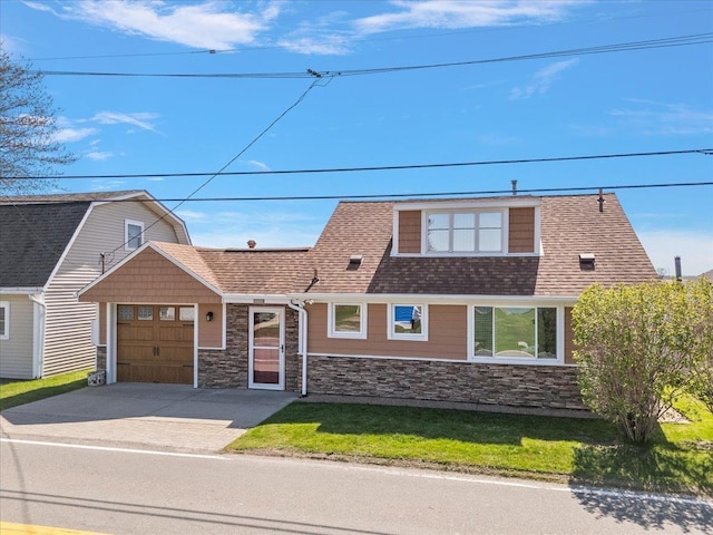 view of front of property with roof with shingles, an attached garage, driveway, and stone siding