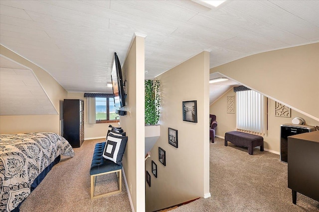 carpeted bedroom with baseboards and vaulted ceiling