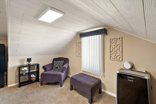 living area with carpet floors, baseboards, and vaulted ceiling
