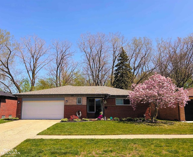 single story home with an attached garage, driveway, a front lawn, and brick siding