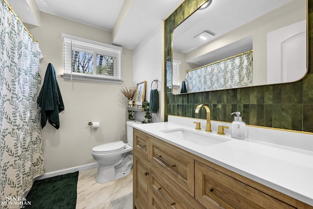 bathroom with vanity, marble finish floor, curtained shower, toilet, and baseboards