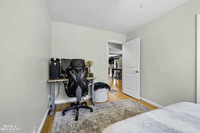 bedroom with baseboards and wood finished floors
