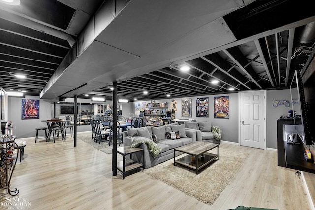 living area featuring baseboards and wood finished floors