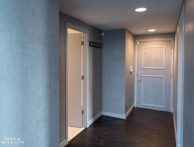 hallway featuring recessed lighting, baseboards, and dark wood-type flooring