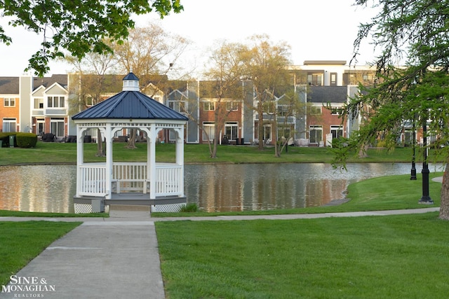 view of community featuring a lawn, a water view, and a gazebo