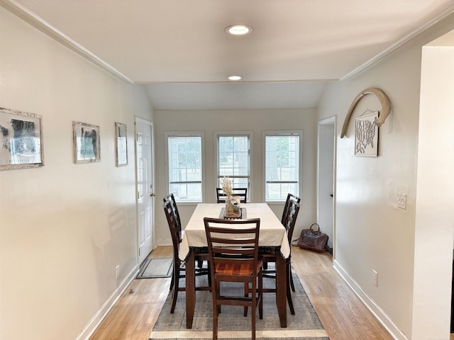 dining room featuring crown molding, baseboards, recessed lighting, and light wood-style flooring
