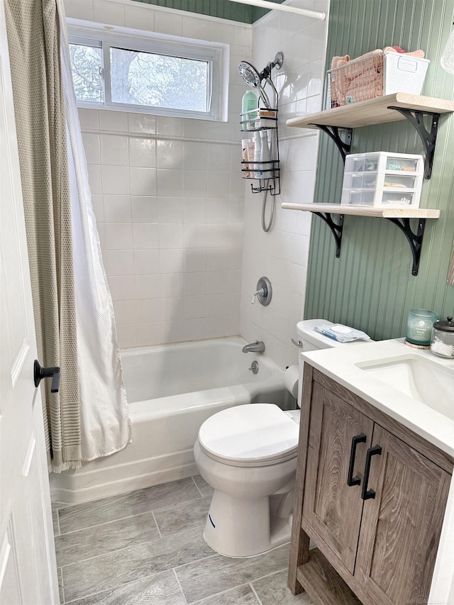 full bathroom with vanity, shower / tub combo with curtain, and toilet