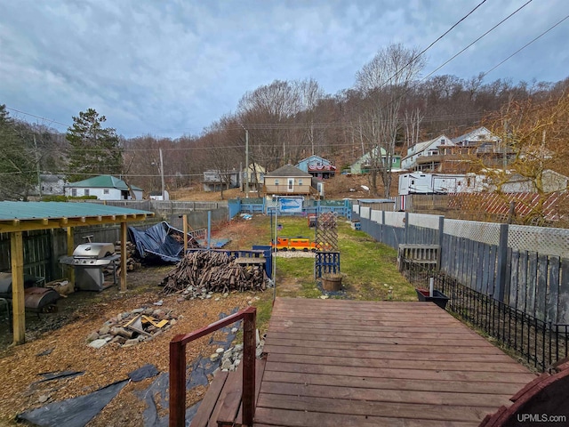 wooden deck with area for grilling and fence