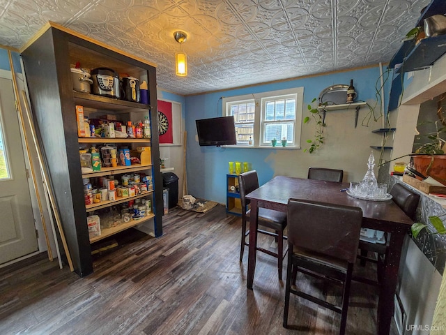 dining area with wood finished floors and an ornate ceiling