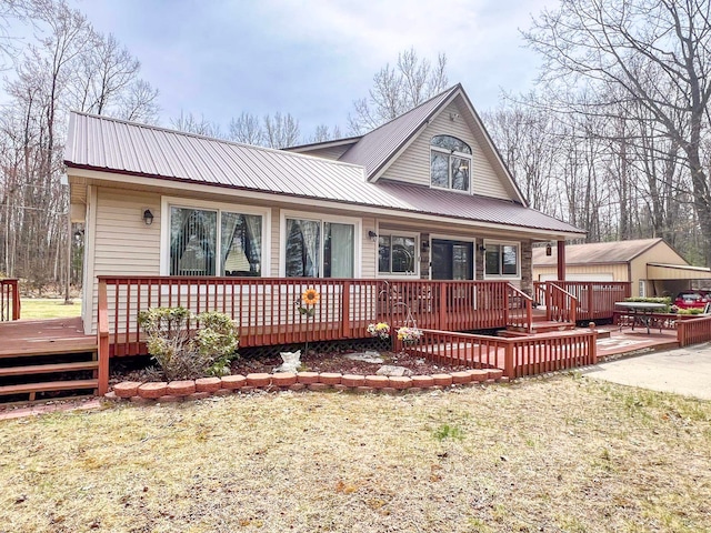 5421 Andrew St, Harrison, MI 48625 - view of front of house with a wooden deck and metal roof