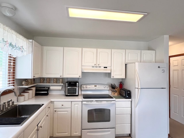 5421 Andrew St, Harrison, MI 48625 - kitchen with white appliances, a sink, under cabinet range hood, and white cabinetry