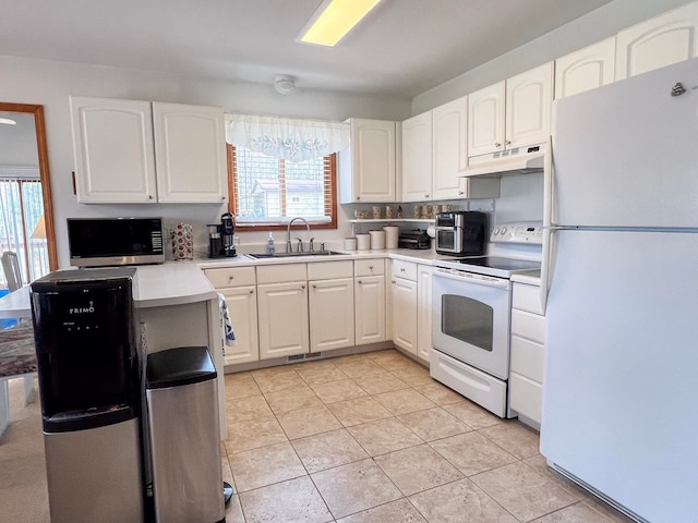 5421 Andrew St, Harrison, MI 48625 - kitchen featuring white appliances, under cabinet range hood, a sink, and white cabinetry