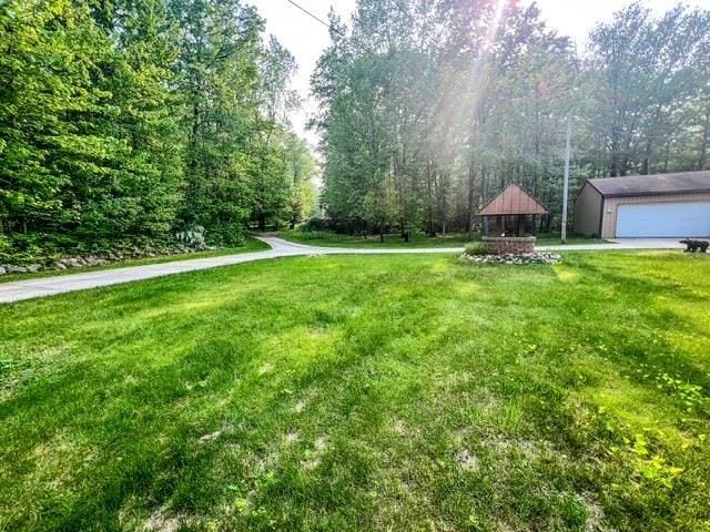 5421 Andrew St, Harrison, MI 48625 - view of green lawn featuring a gazebo and an outdoor structure