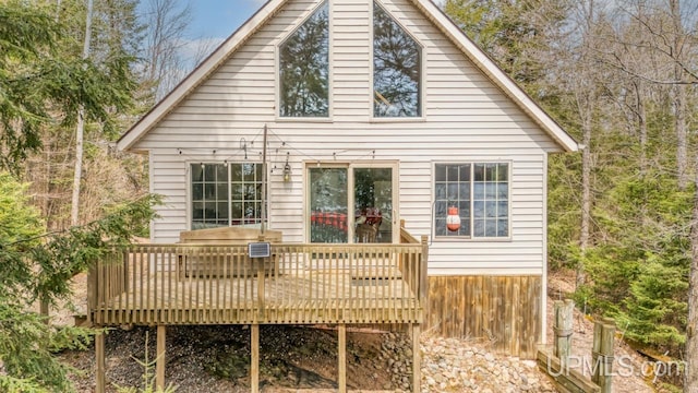 rear view of property featuring a wooden deck