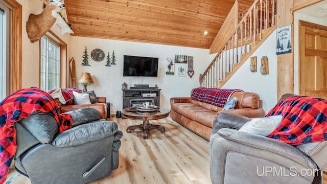 living area with wood ceiling, lofted ceiling, wood finished floors, and stairway