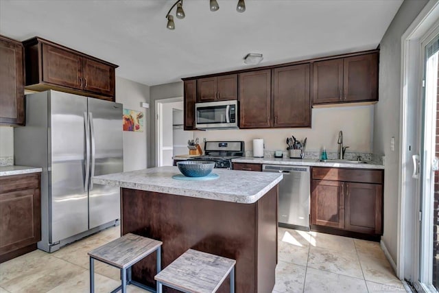 29094 Herbert St, Madison Heights, MI 48071 - kitchen featuring dark brown cabinetry, a sink, light countertops, a center island, and stainless steel appliances