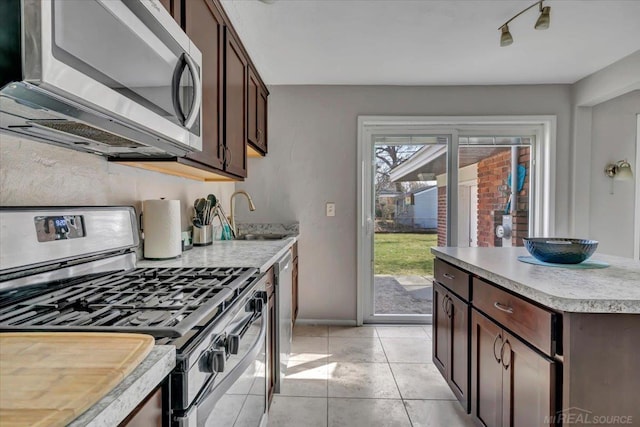29094 Herbert St, Madison Heights, MI 48071 - kitchen featuring light tile patterned flooring, dark brown cabinetry, a sink, light countertops, and stainless steel appliances