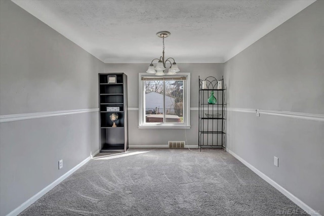 29094 Herbert St, Madison Heights, MI 48071 - unfurnished dining area featuring visible vents, an inviting chandelier, baseboards, a textured ceiling, and carpet flooring