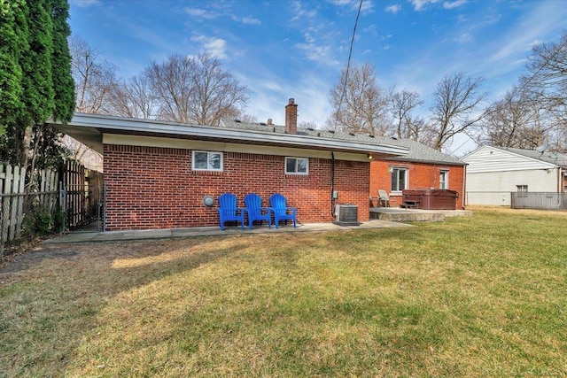 29094 Herbert St, Madison Heights, MI 48071 - rear view of house featuring brick siding, a hot tub, fence, and a chimney