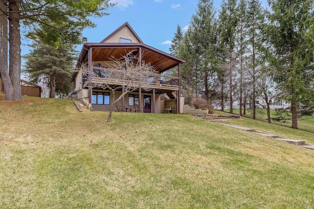 rear view of house featuring a lawn, a wooden deck, and stairway
