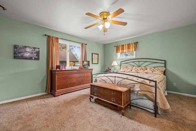 bedroom with baseboards, carpet flooring, and a ceiling fan