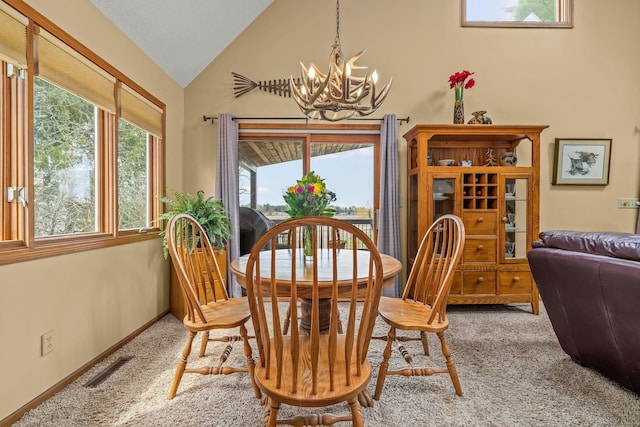 dining room with carpet floors, visible vents, vaulted ceiling, and a chandelier
