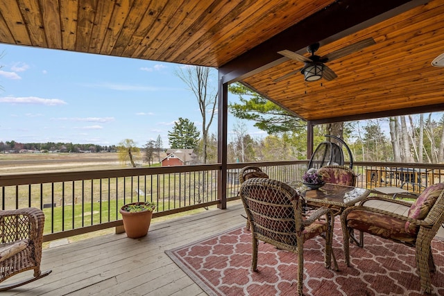 wooden deck featuring a ceiling fan