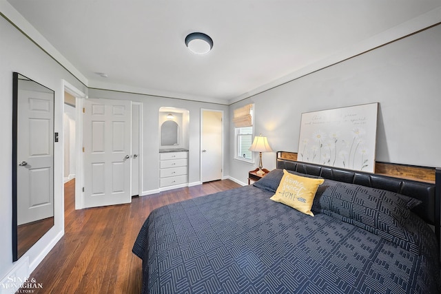 bedroom featuring baseboards and wood finished floors