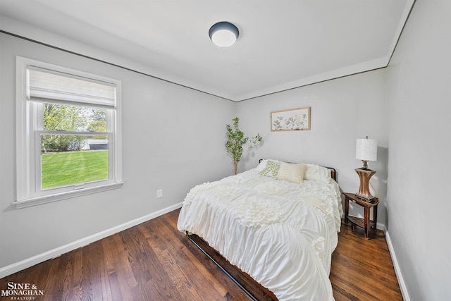 bedroom featuring baseboards and wood finished floors