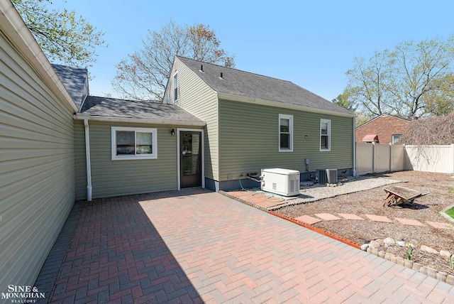 rear view of property with central AC, a patio area, and fence