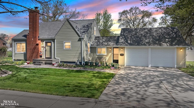 view of front facade with roof with shingles, a garage, a front yard, a chimney, and driveway
