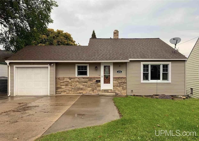 view of front facade featuring a chimney, a front yard, an attached garage, a shingled roof, and stone siding